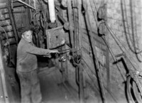 Mann an der Ofenklappe im Kesselhaus, 20. April 1961.